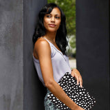 A yong girl holding personalized microsoft surface laptop case with Polka Dot design